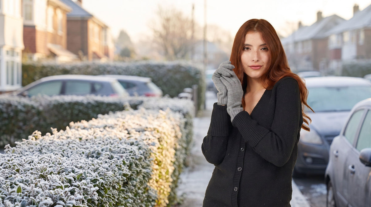 Woman wearing Slate Heather FibreHeat merino wool gloves on a frosty street