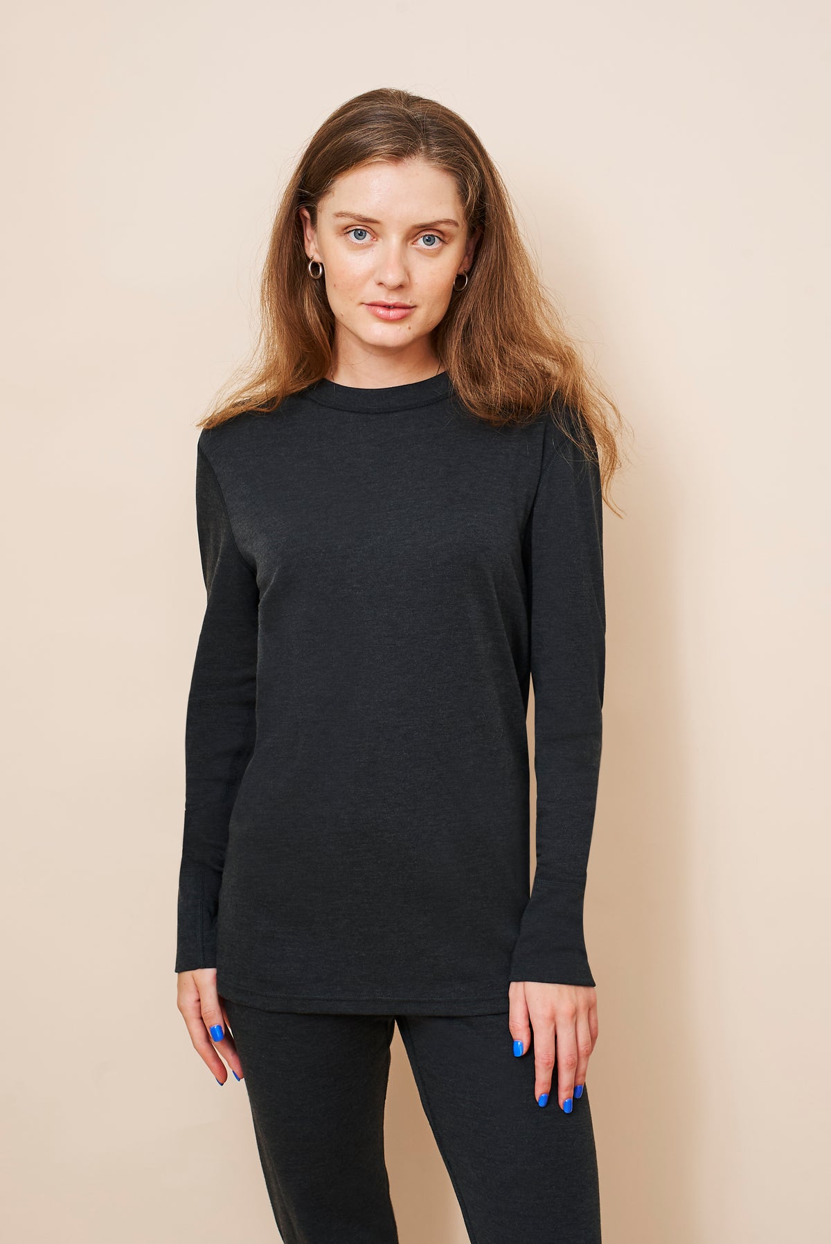 Woman wearing the black unisex FibreHeat base layer shirt