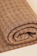 Close-up of the Toast throw blanket’s diamond knit texture