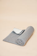Slate self-heating knit throw blanket, rolled, showing the diamond knit and the FibreHeat back