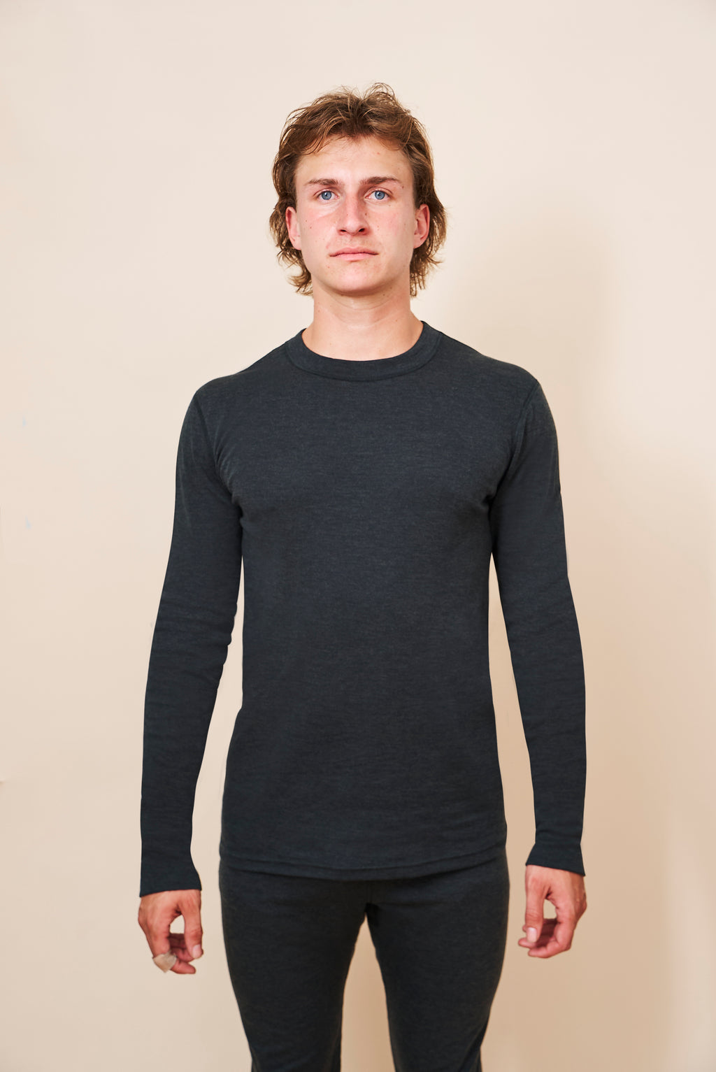 Man wearing the black unisex FibreHeat base layer shirt