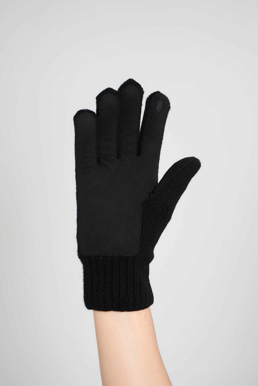 Black merino wool glove with a leather palm patch, palm view