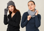 Two models wearing the gray heather cashmere gloves and the gray and ecru neck warmer