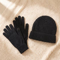 Winter Wonderland bundle: black merino self-heating gloves and black knit beanie on a cream knit throw