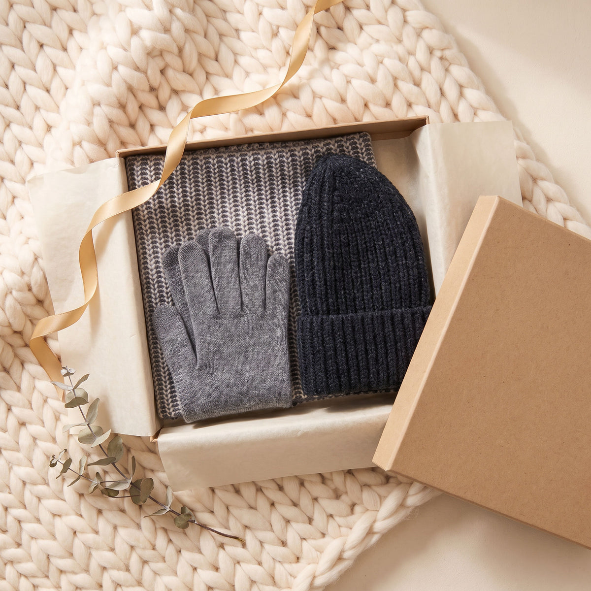 FibreHeat cashmere gloves, neck warmer and knit beanie in an open kraft gift box with a gold ribbon