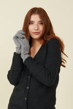 Woman in a black cardigan wearing Slate Heather grey self-heating merino wool gloves