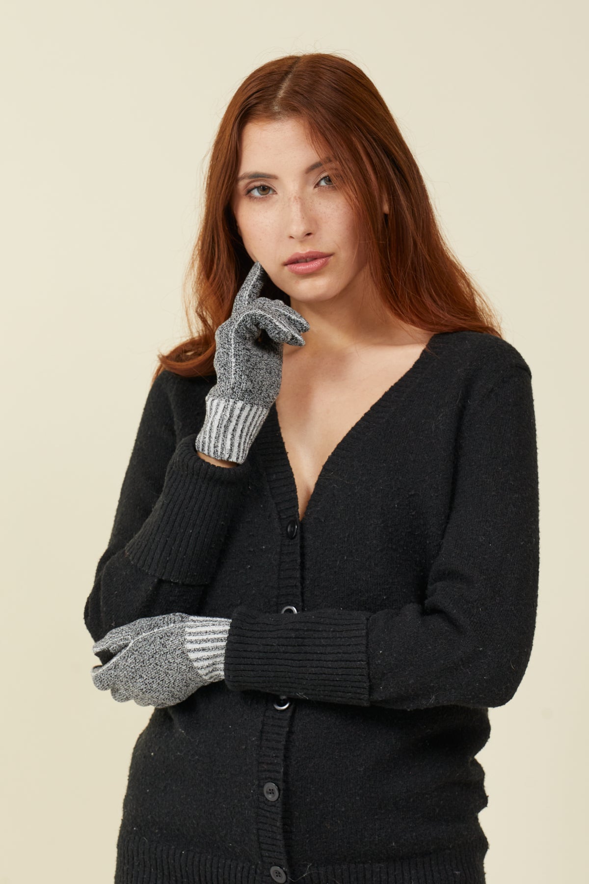 Woman in a black cardigan wearing Charcoal Twist FibreHeat Ultra Liners, hand to her cheek